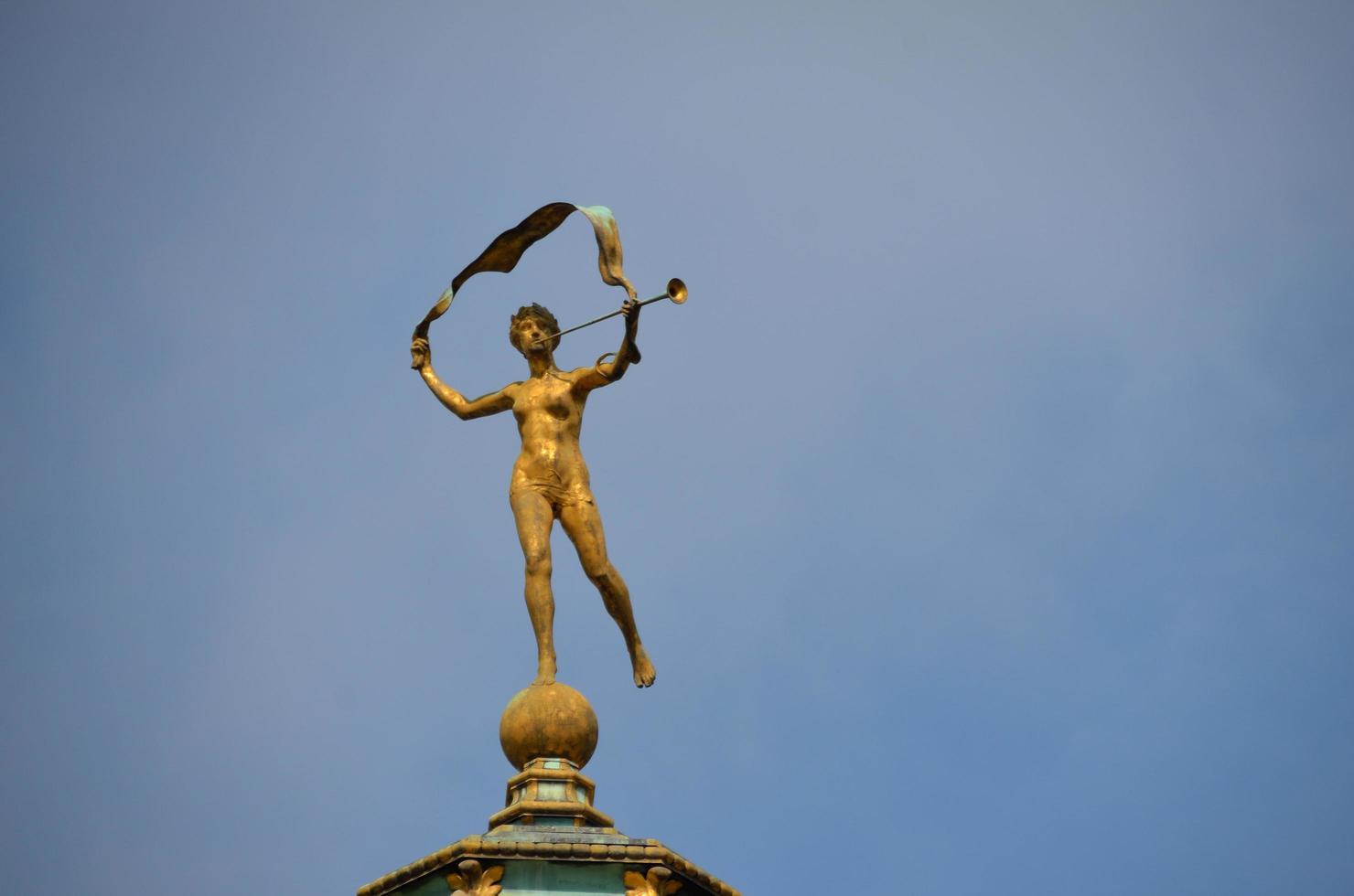 golden figure on a roof photo