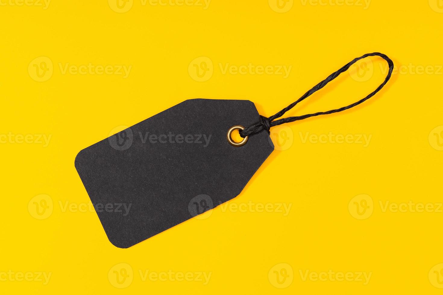 Black price Tag isolated on yellow background. Template mock up photo
