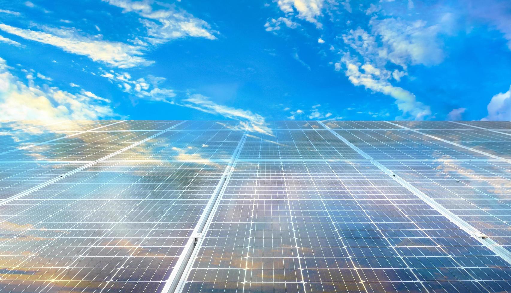 Solar panels on blue sky background photo