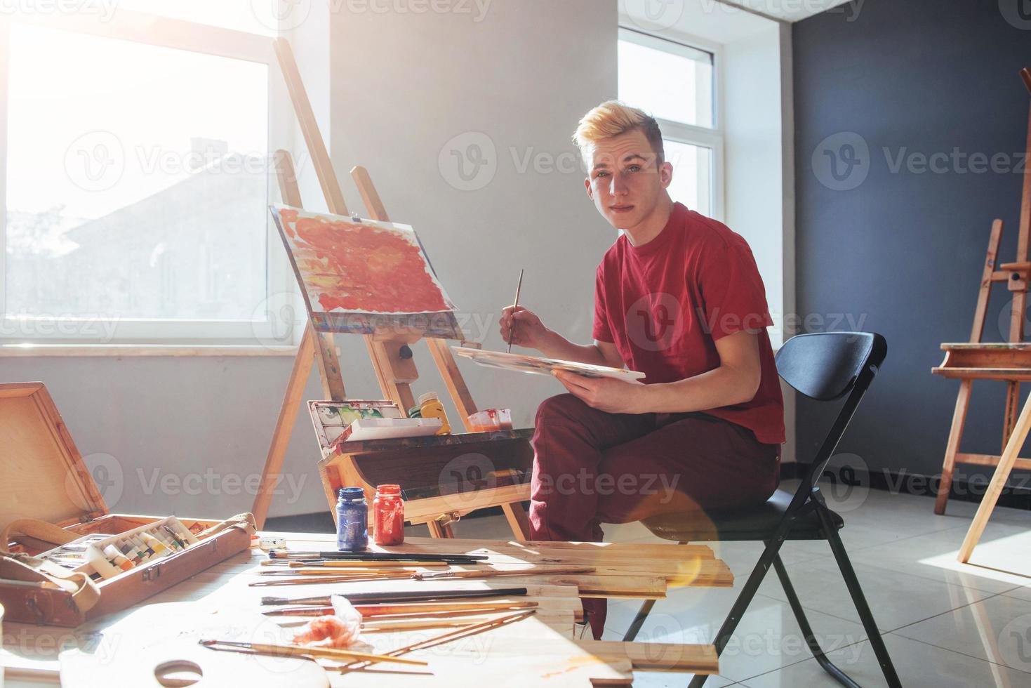 artist painting a picture in a studio photo