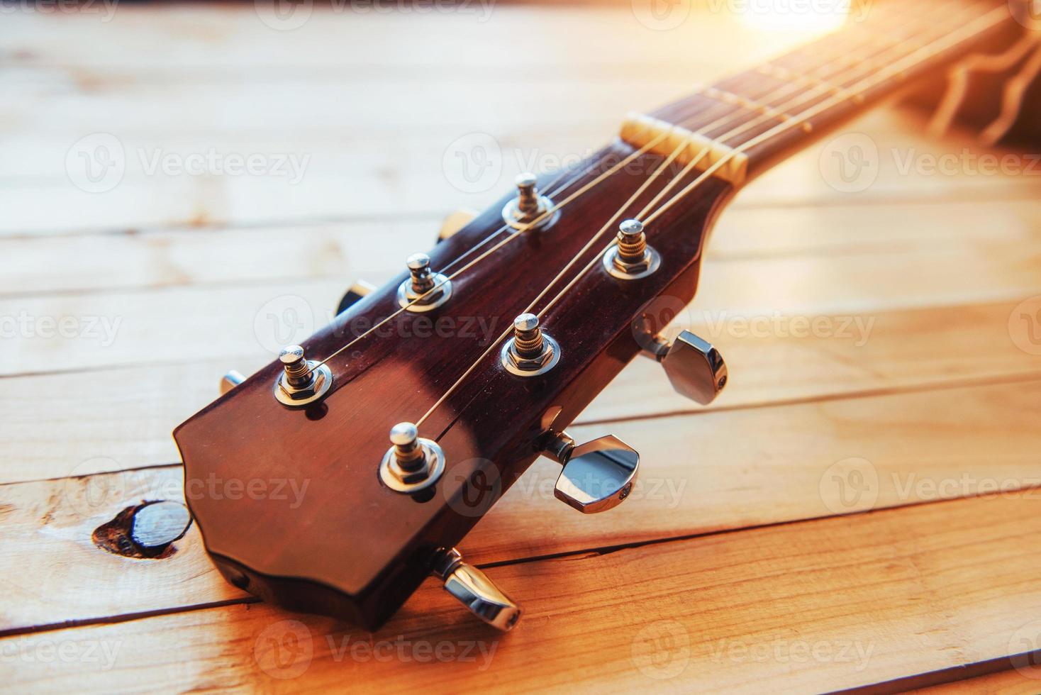close up neck acoustic classical guitar on a light wooden background photo