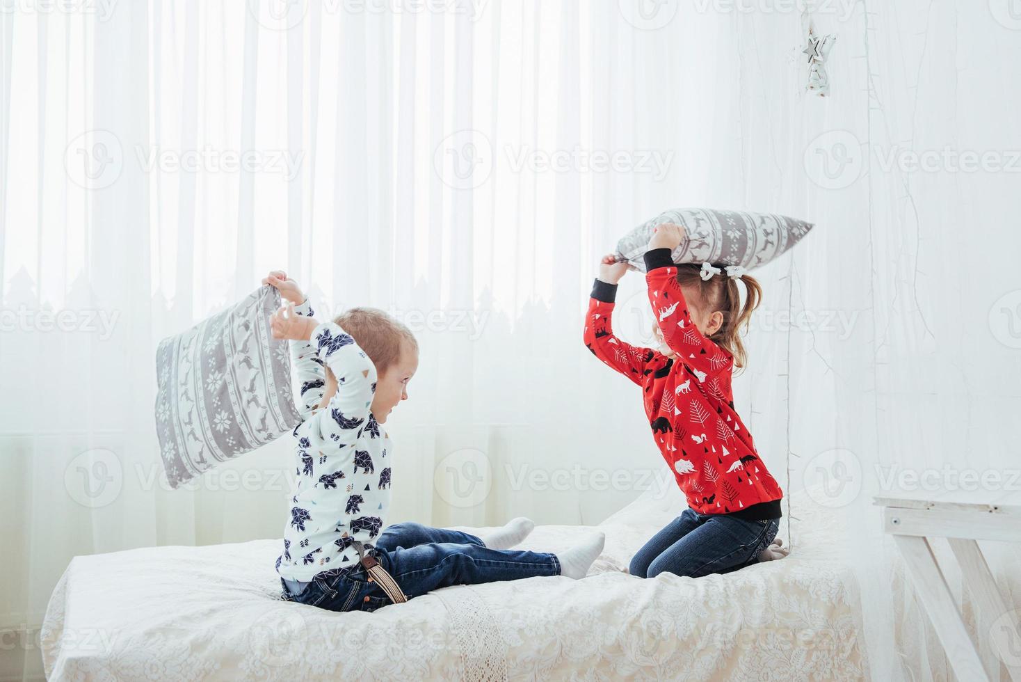 Child in soft warm pajama playing in bed photo