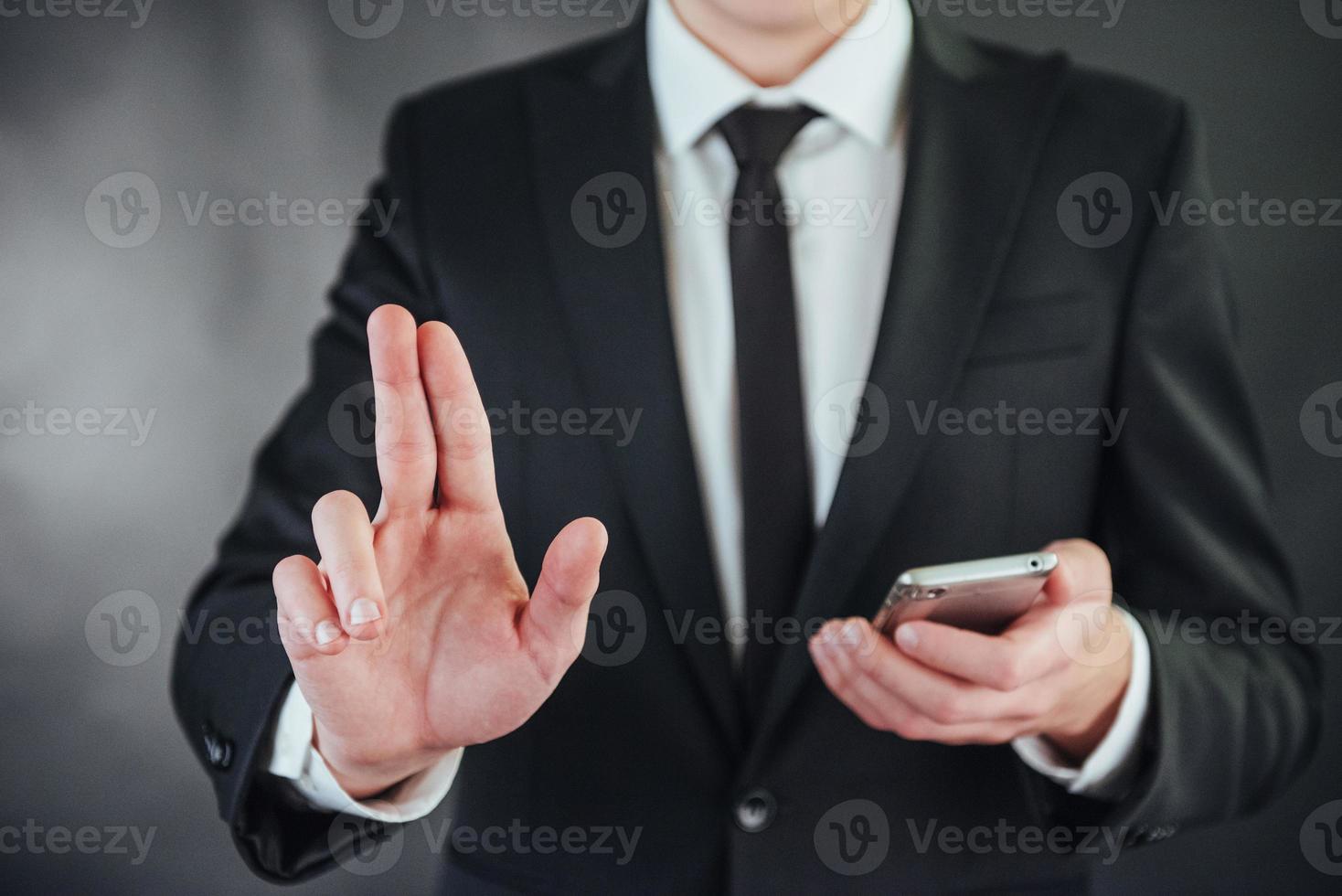 Businessman hand pointing on empty space on black background photo