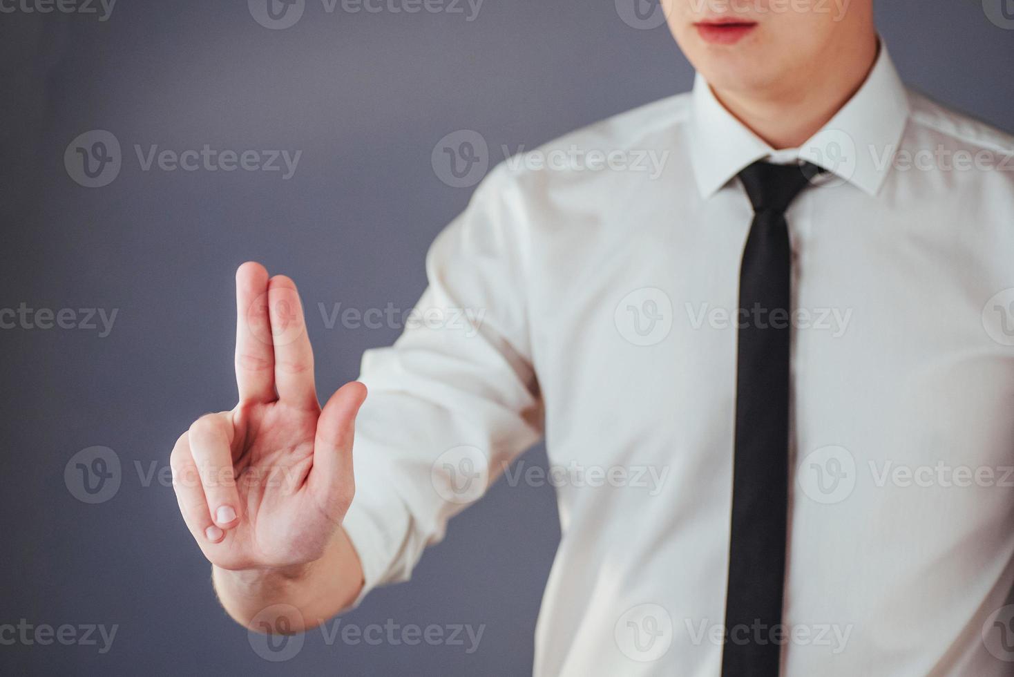 Businessman hand pointing on empty space on black background photo