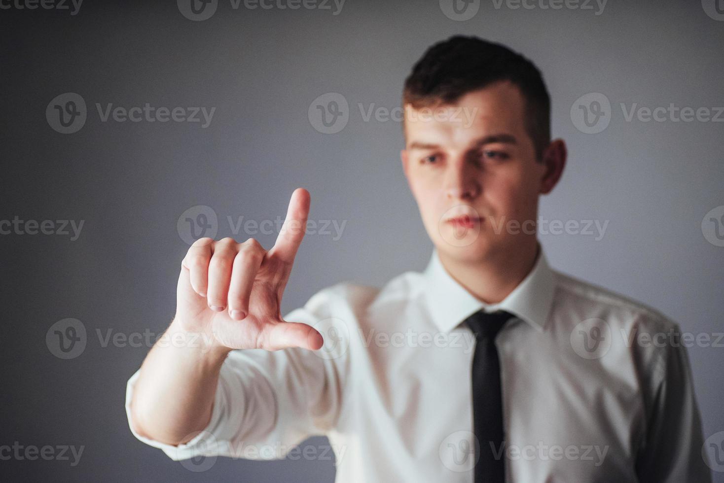 Businessman hand pointing on empty space on black background photo