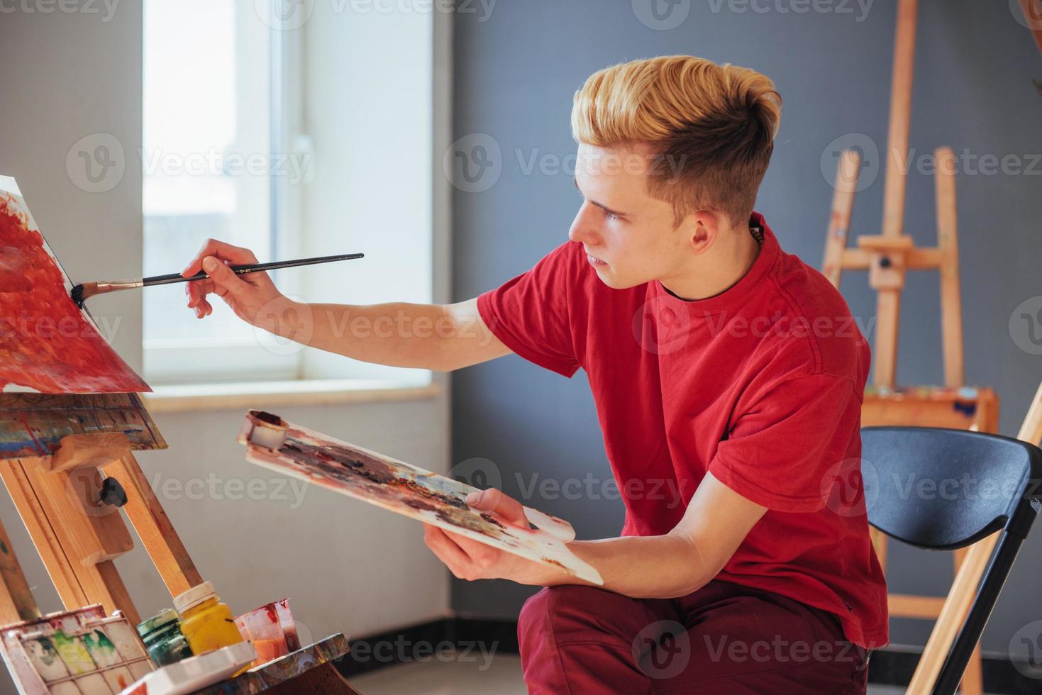 artist painting a picture in a studio photo