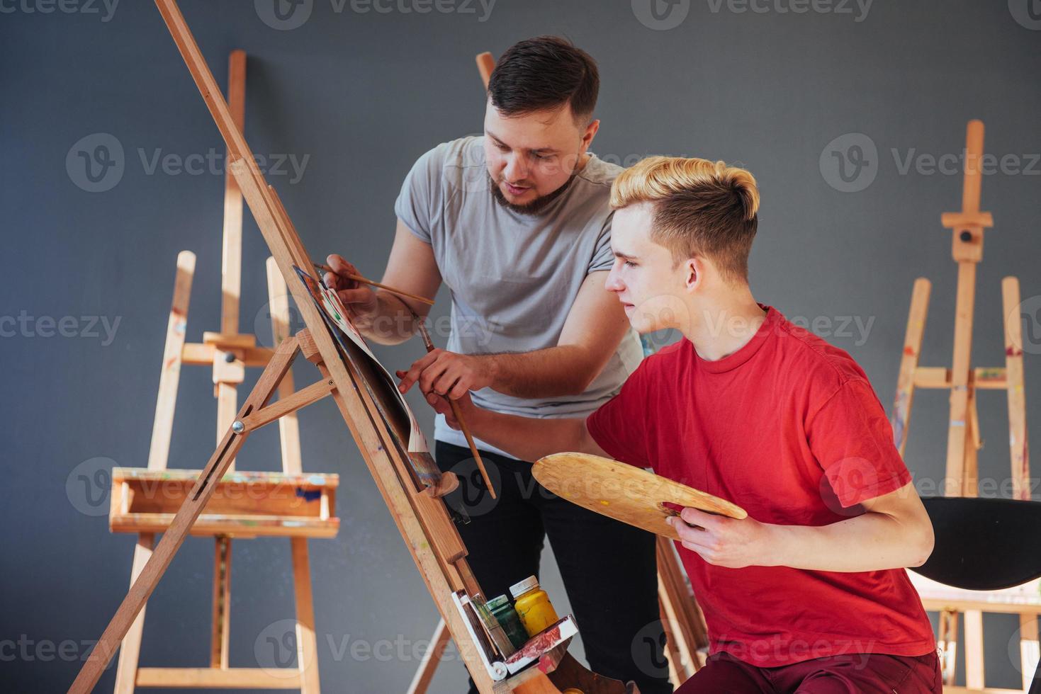 Group of students painting at art lessons photo