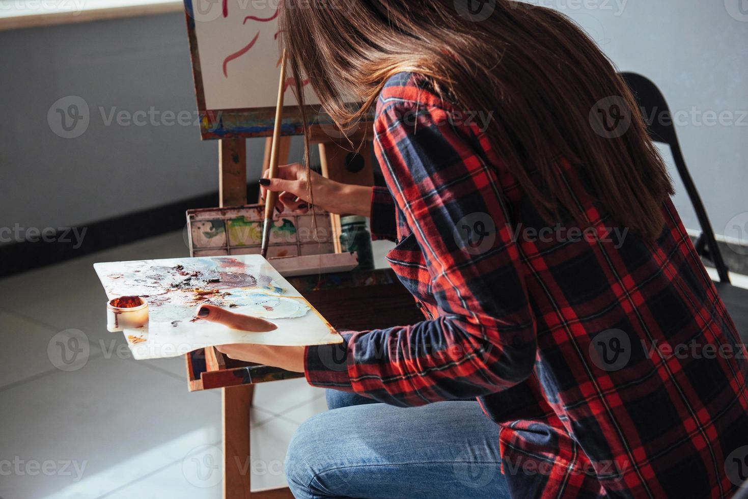 Pretty Pretty Girl artist paints on canvas painting on the easel. photo