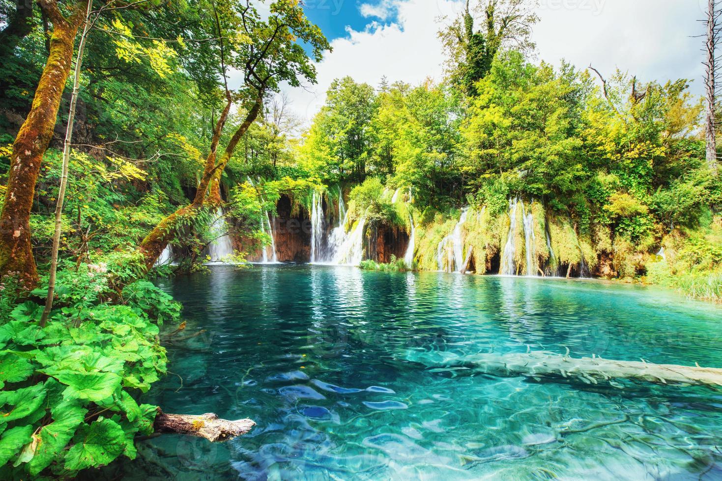 Waterfalls in national park falling into turquoise lake. Plitvice, Croatia photo