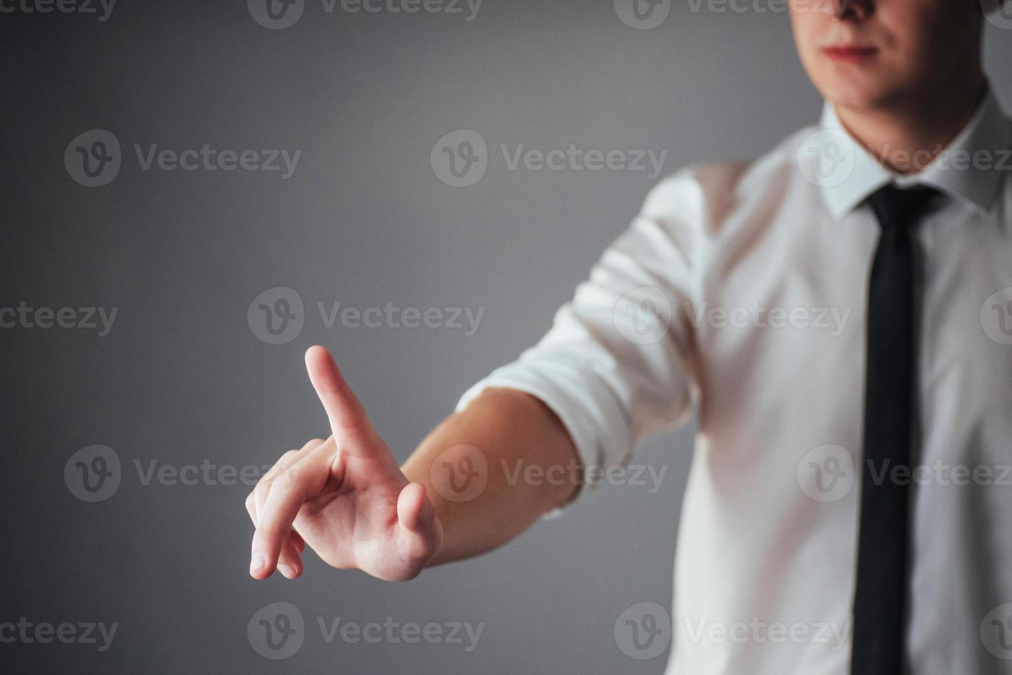 Businessman hand pointing on empty space on black background photo