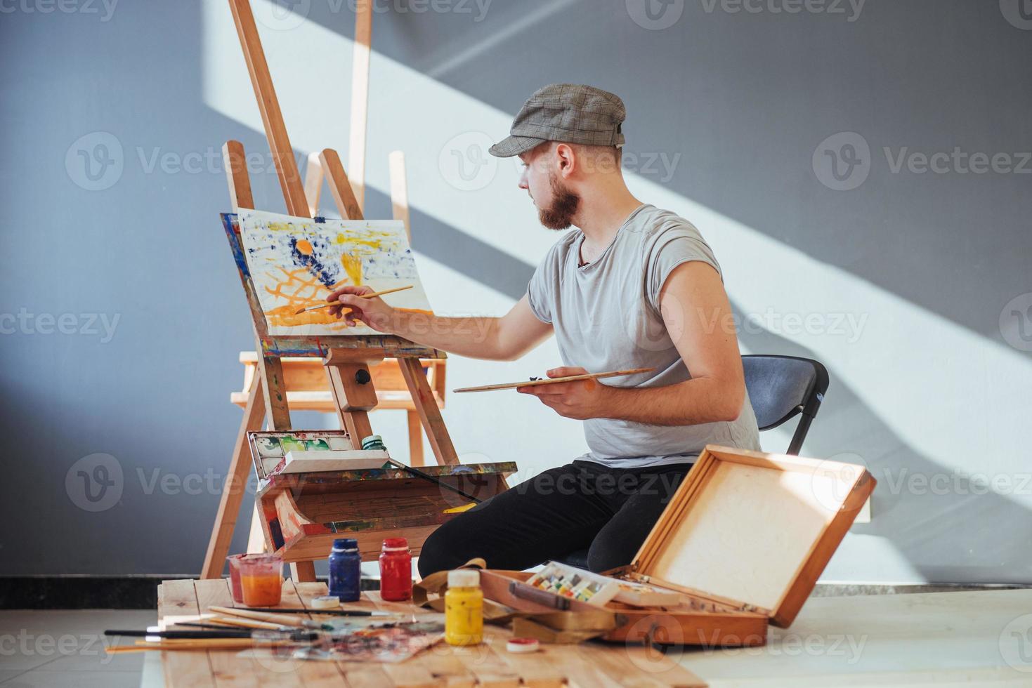 artist painting a picture in a studio photo