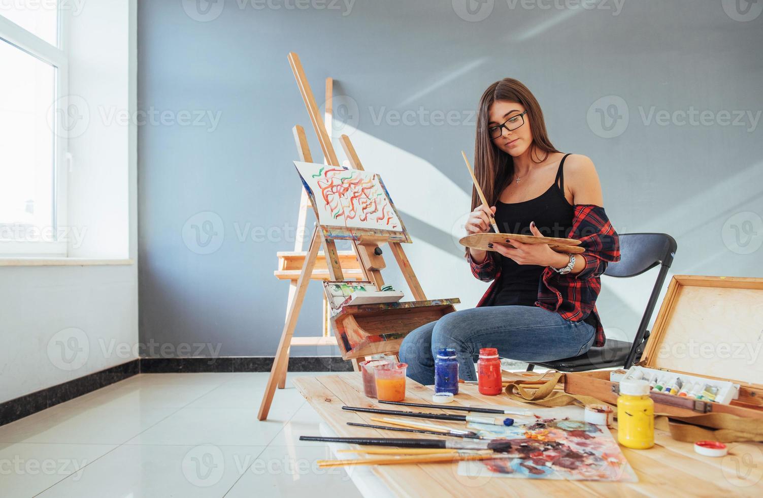 Pretty Pretty Girl artist paints on canvas painting on the easel photo