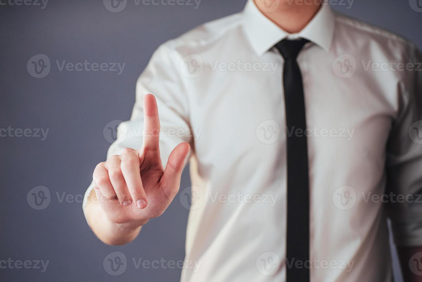 Businessman hand pointing on empty space on black background photo