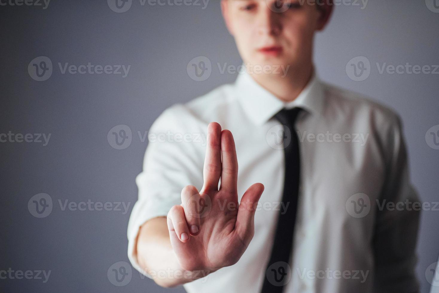 Businessman hand pointing on empty space on black background photo
