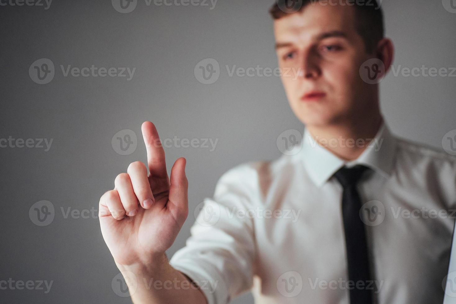 Businessman hand pointing on empty space on black background photo
