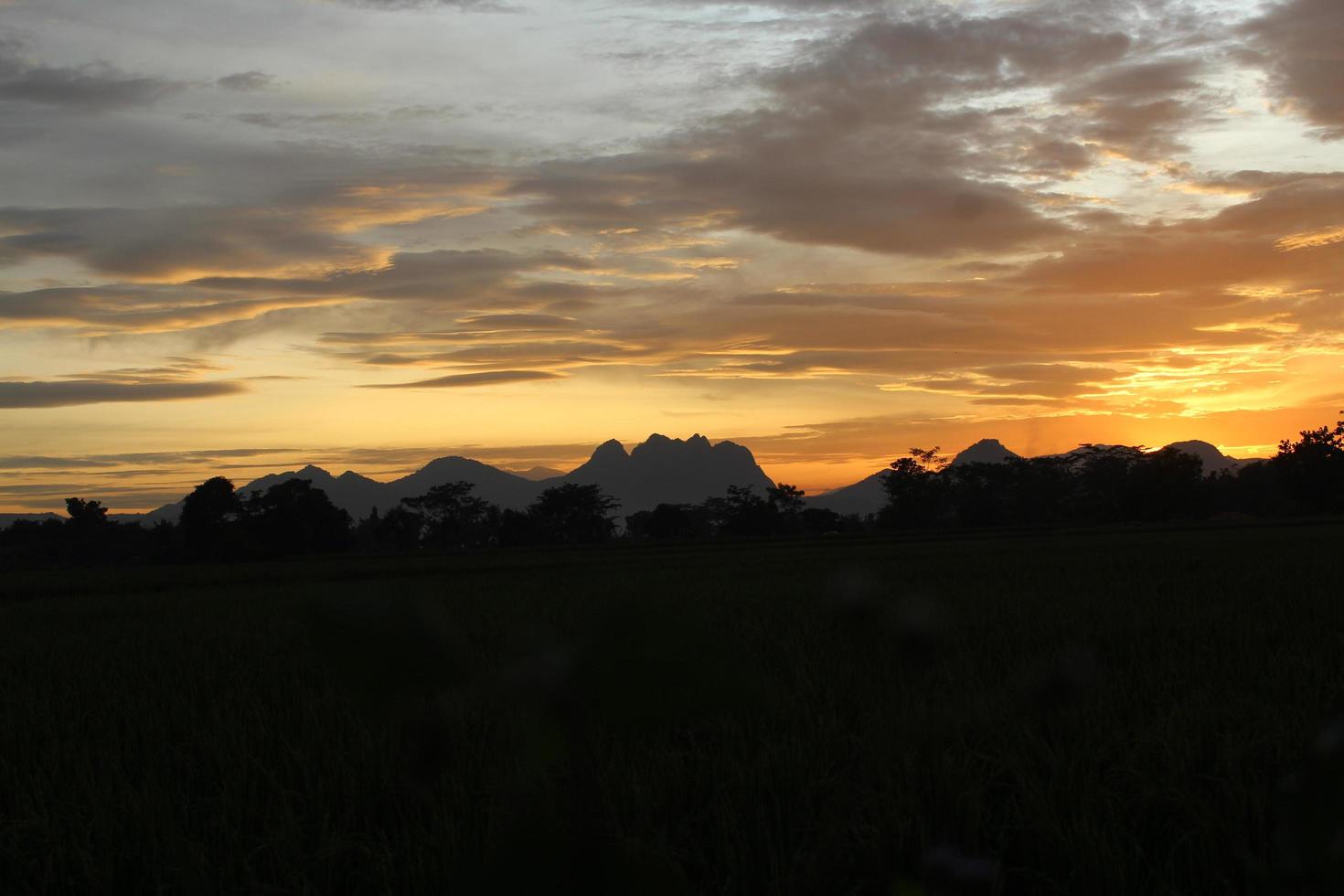 Mountain silhouette with sunset background photo