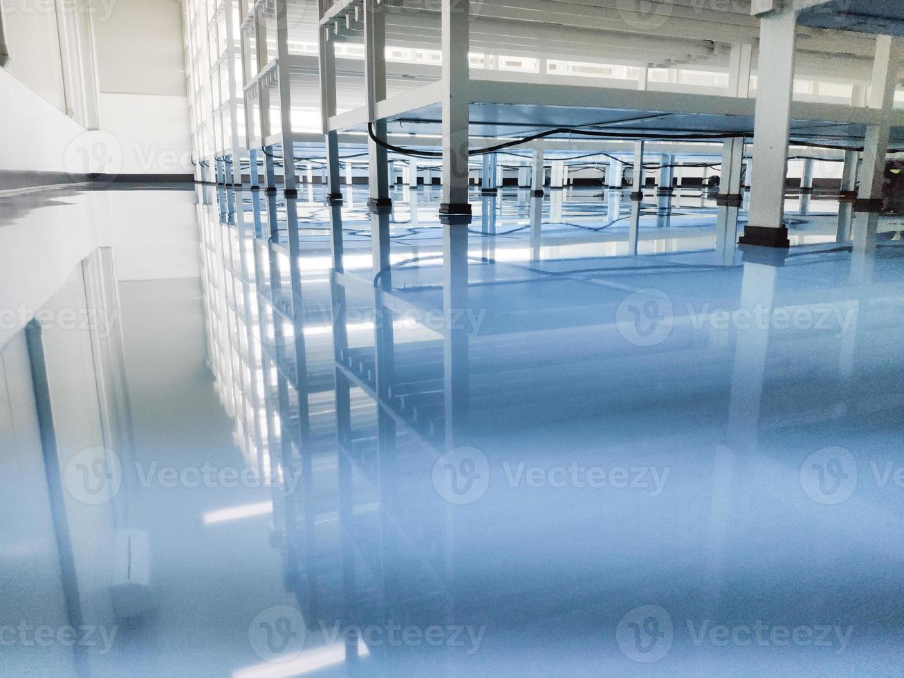 a cable under rack legs at sea blue epoxy floor.Industrial epoxy floor photo