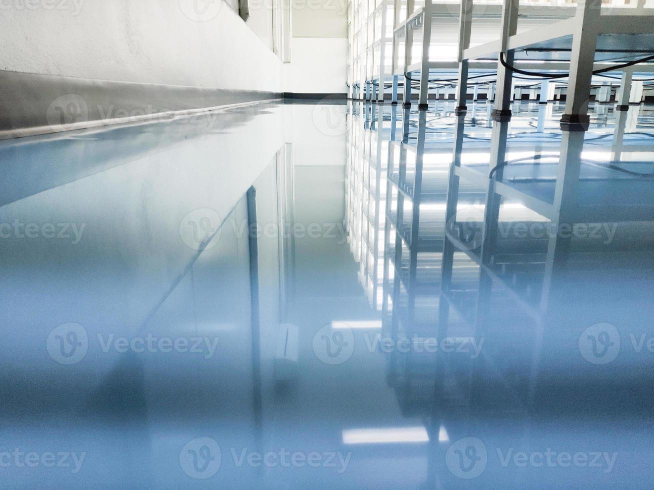 a cable under rack legs at sea blue epoxy floor.Industrial epoxy floor photo