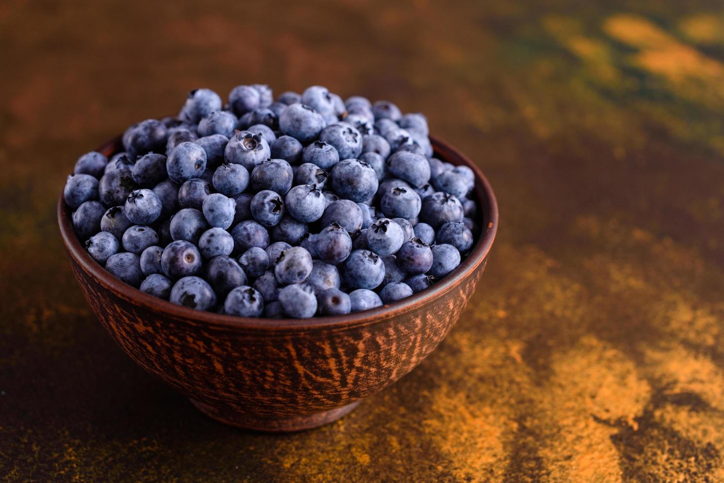 Beautiful fresh delicious blueberries on a black plate photo