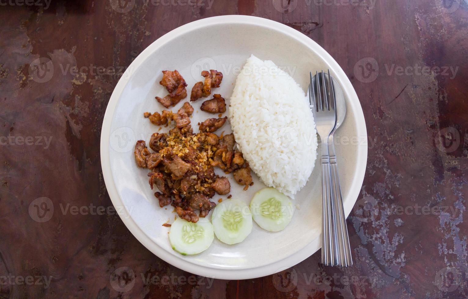 Fried pork with garlic and pepper and rice photo