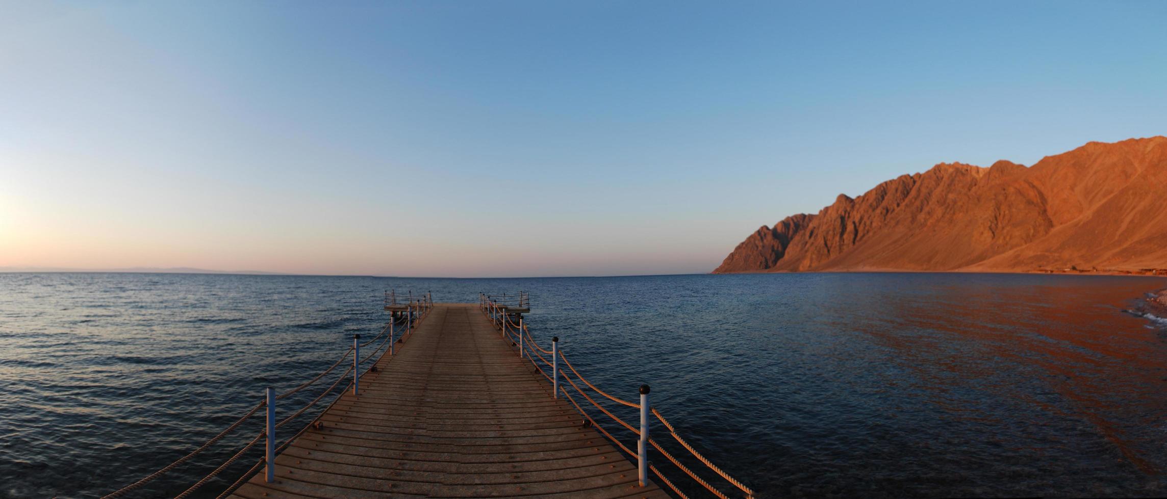 jetty with mountain panorama photo