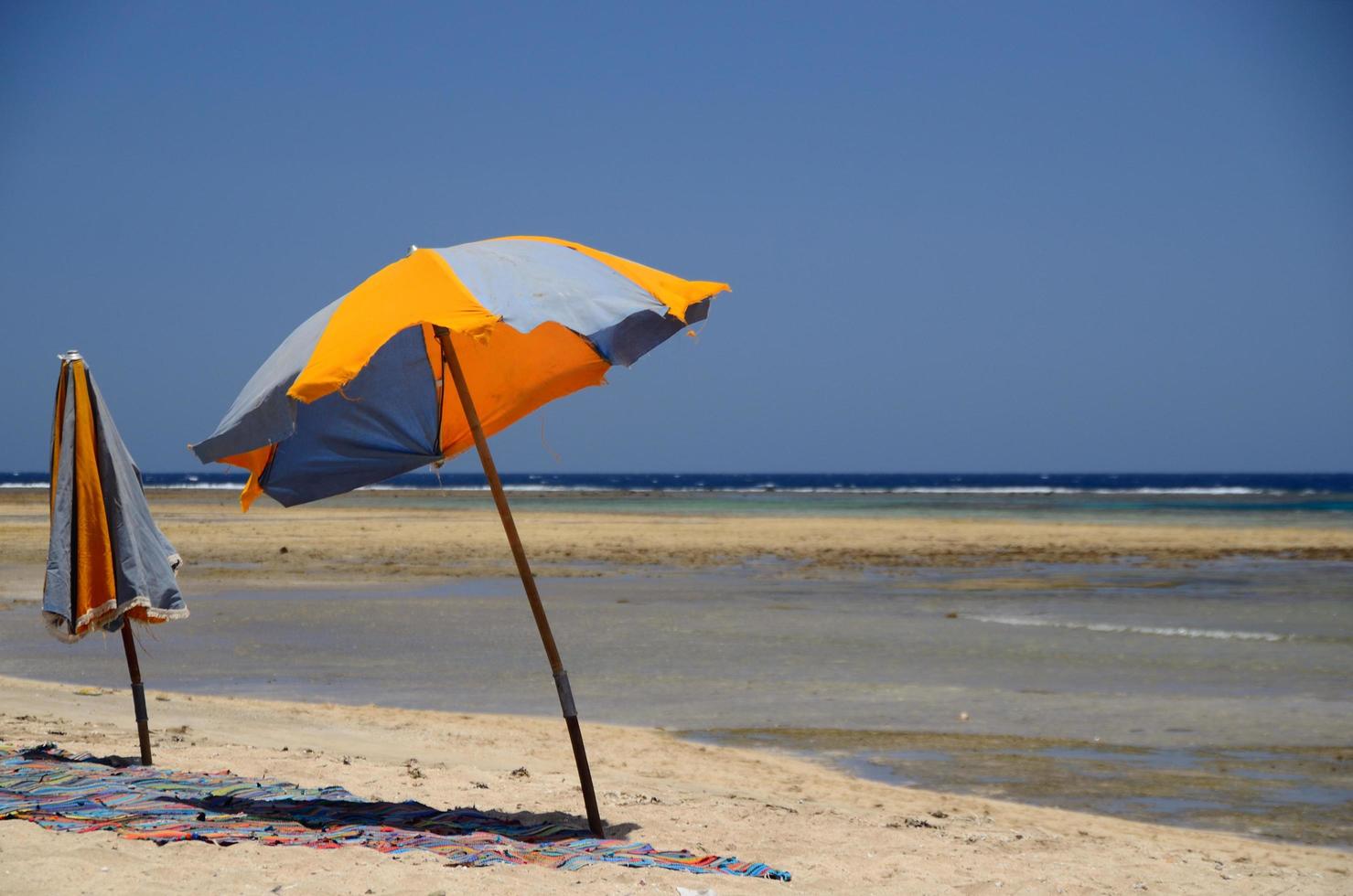 two colorful umbrellas at sea photo