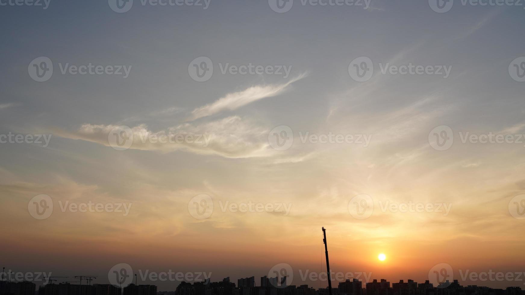 The beautiful sunset view with the silhouette and colorful clouds sky in the city photo