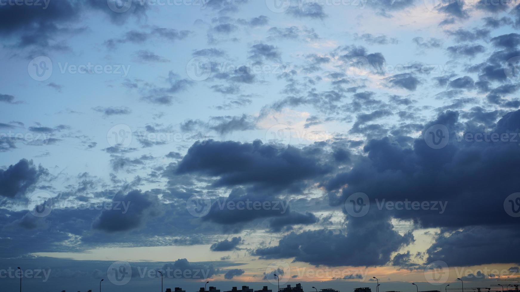 The beautiful sunset view with the silhouette and colorful clouds sky in the city photo