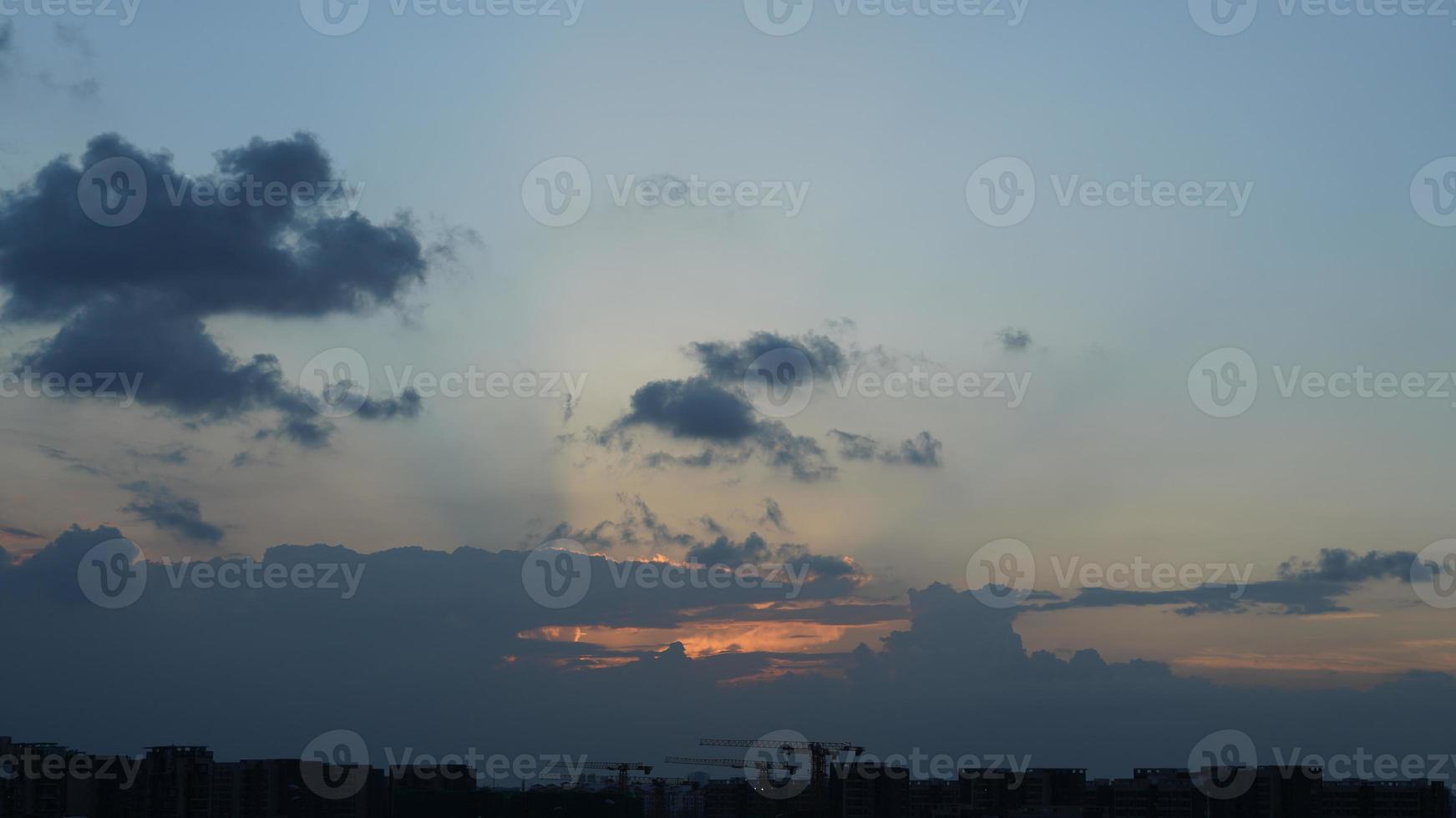 The beautiful sunset view with the silhouette and colorful clouds sky in the city photo