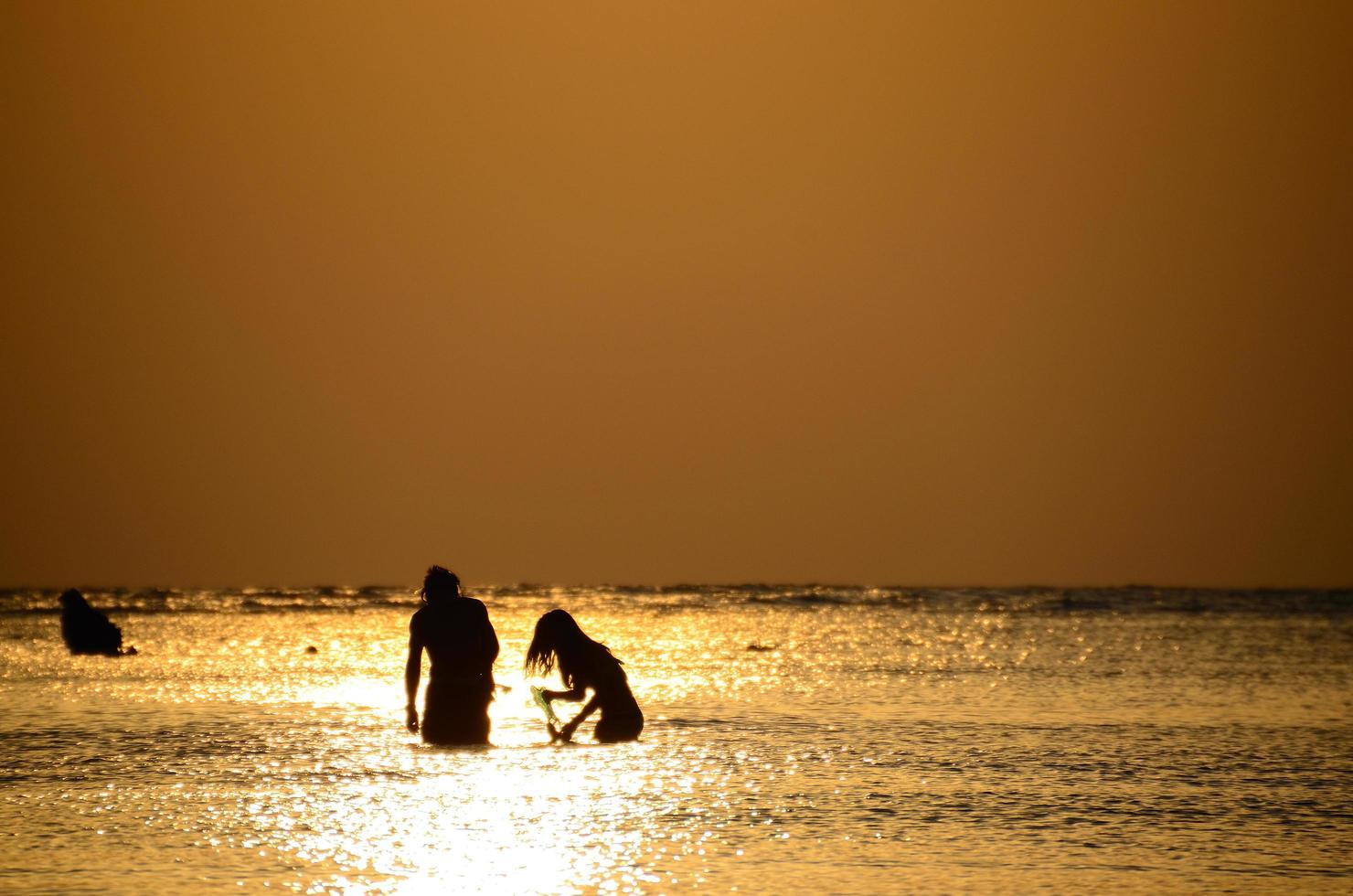 couple snorkeling at sunrise photo