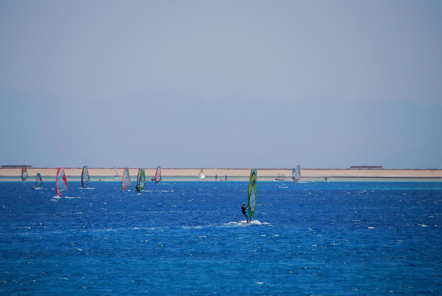 many windsurfer on the sea and beach photo