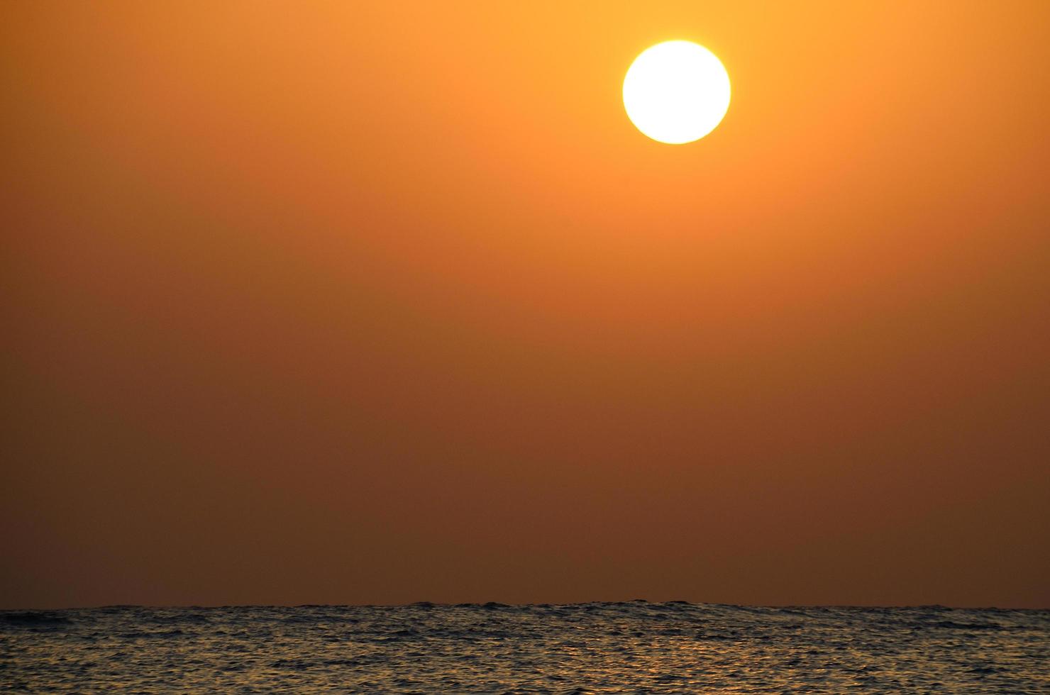 sunrise on sea with waves photo