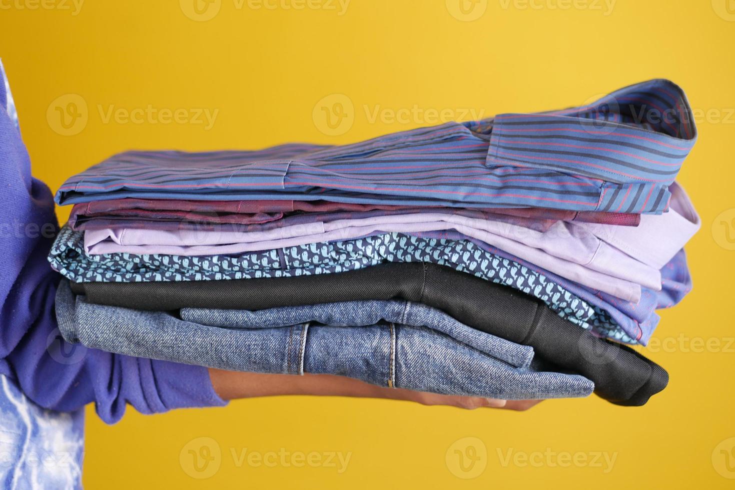 Close up of holding stack of cloths on table. photo