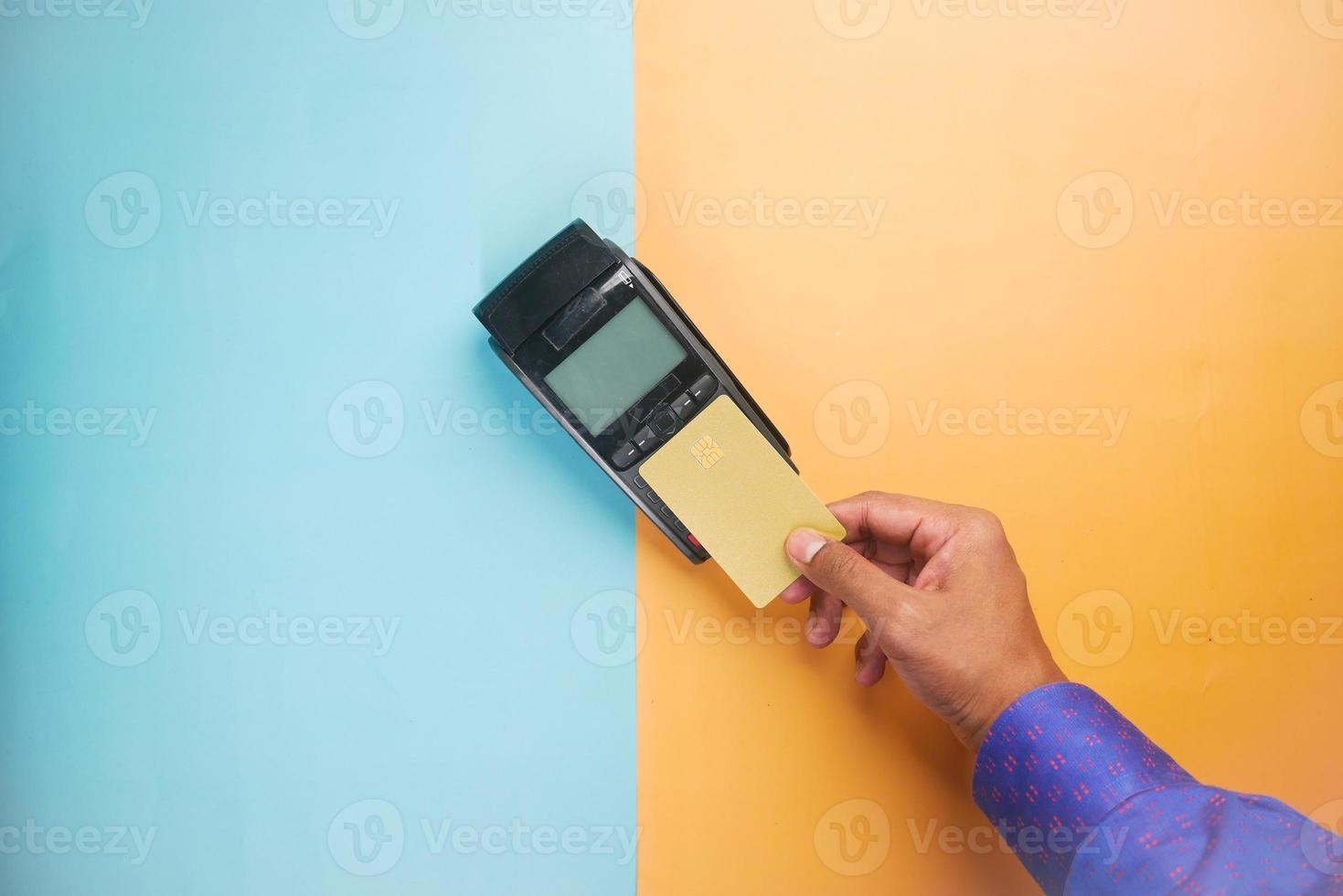 contactless payment concept with young man paying with credit card photo