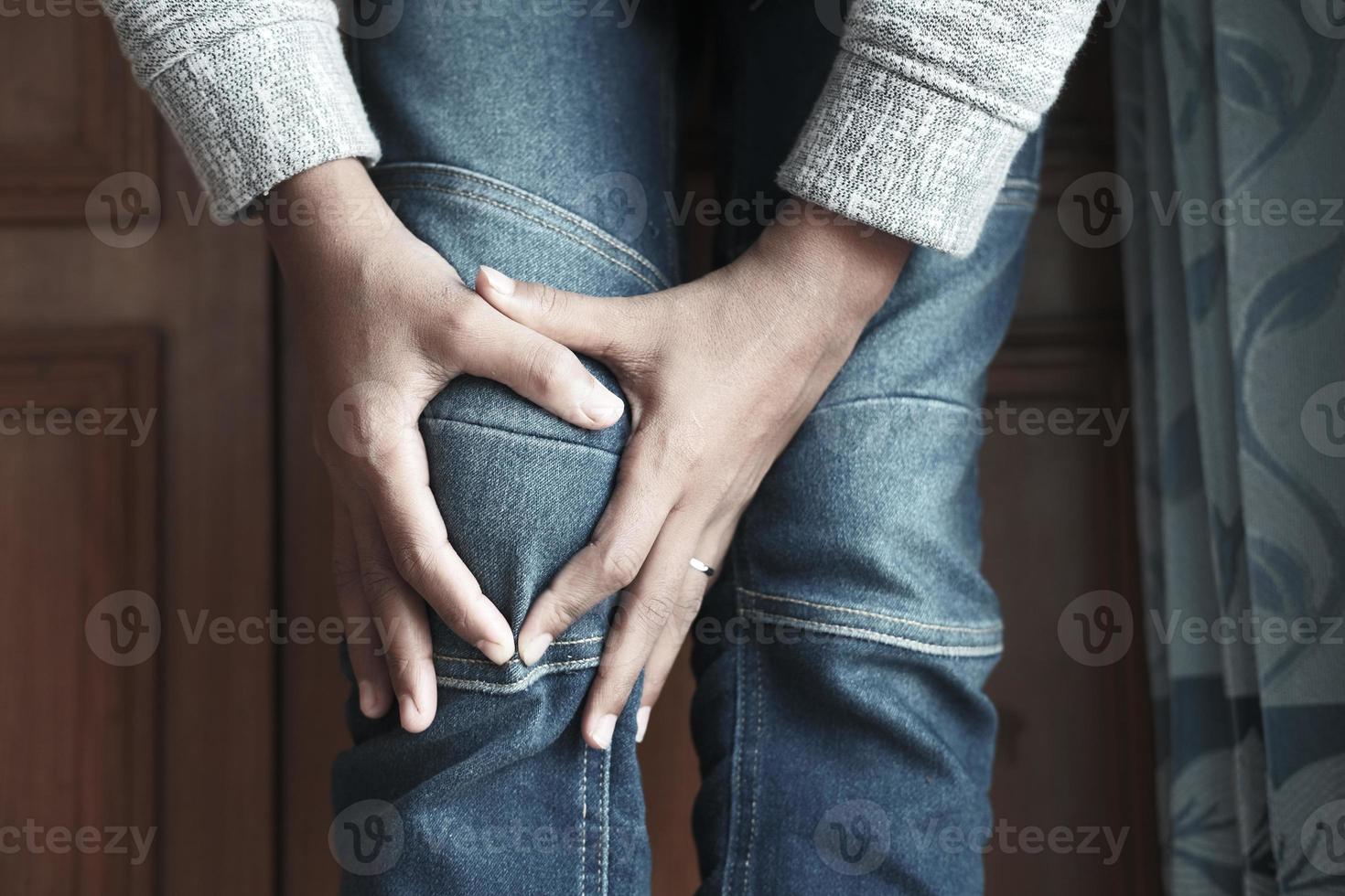 Close up on man suffering knee joint pain photo