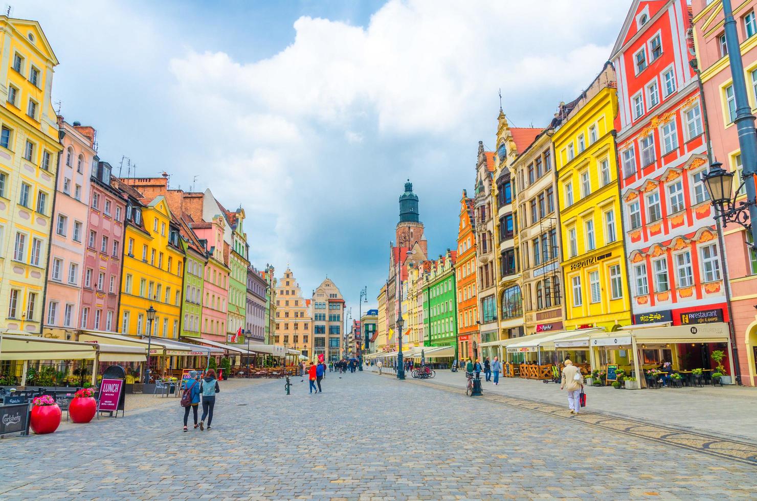Wroclaw, Poland, May 7, 2019 old town historical city centre, colorful buildings with multicolored facade, St. Elizabeth Minor Basilica Garrison catholic Church on cobblestone Rynek Market Square photo
