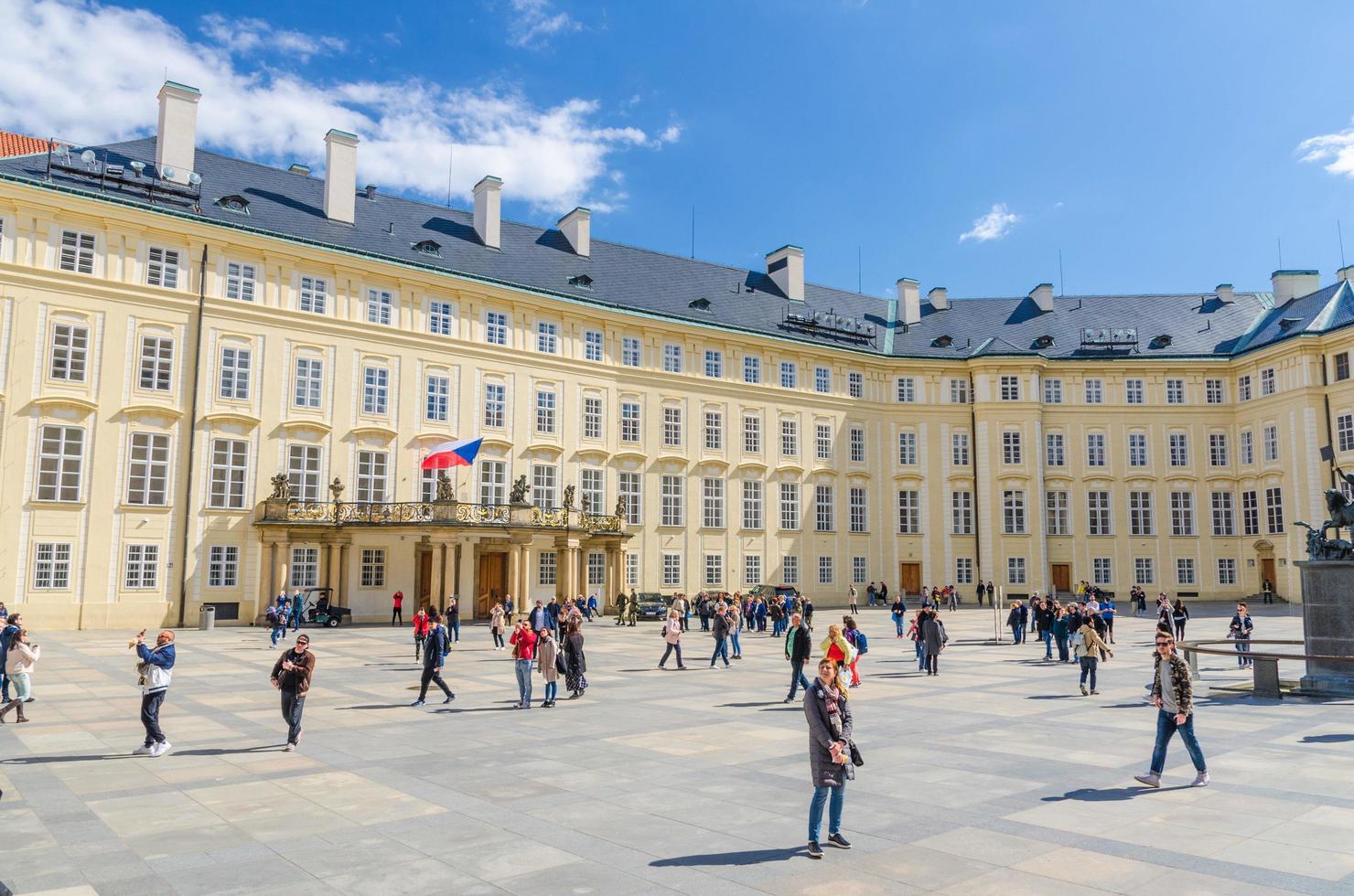Prague, Czech Republic, May 13, 2019 courtyard square with The Archive of the Prague Castle and Old Royal Palace buildings, walking people tourists, Mala Strana Lesser Town, Bohemia photo