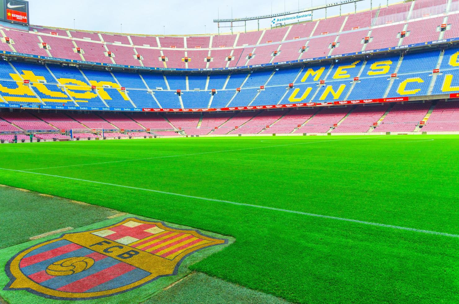 Barcelona, Spain, March 14, 2019 Camp Nou is the home stadium of football club Barcelona, the largest stadium in Spain. View of tribunes stands, green grass field and logo from reserves bench. photo