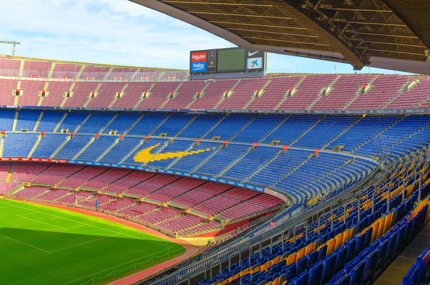 Barcelona, Spain, March 14, 2019 Camp Nou is the home stadium of football club Barcelona, the largest stadium in Spain. Top aerial view of tribunes stands, green grass field and scoreboard. photo