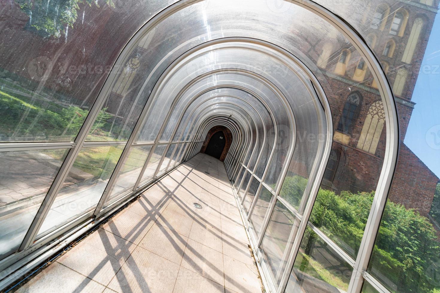 Soundproofing tunnel, plastic fence, Modern transparent noise protection in city downtown. photo
