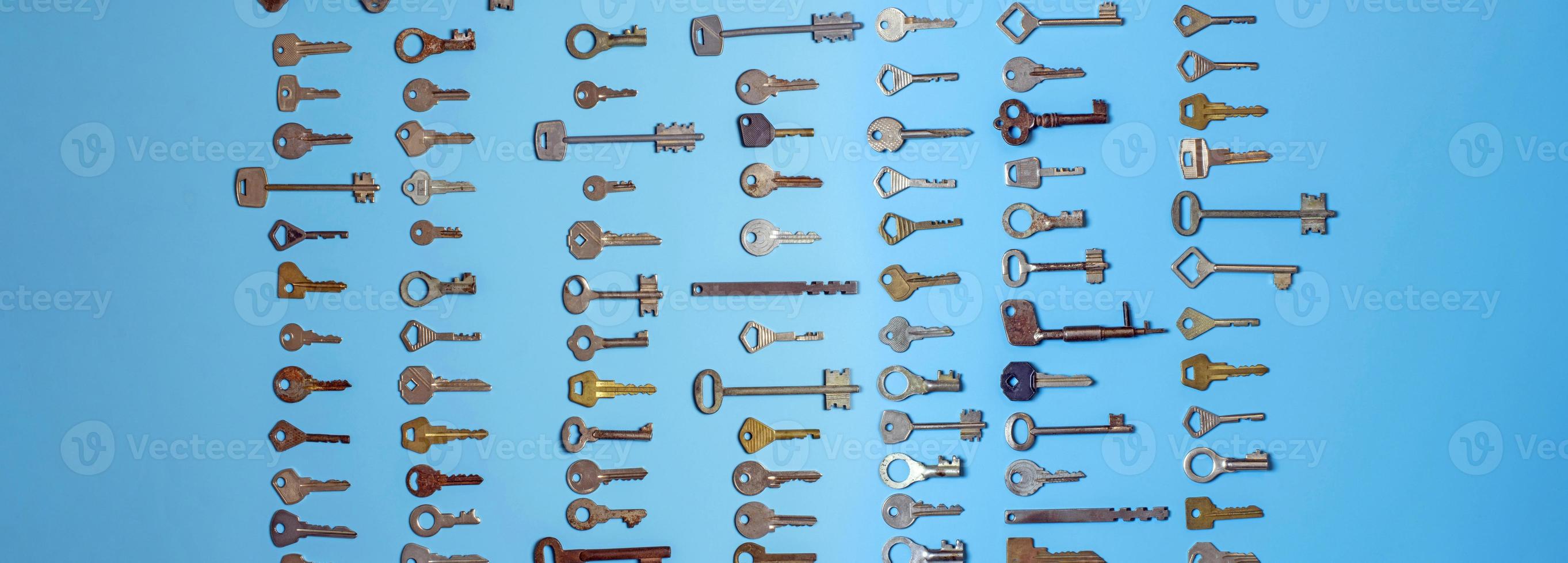 Keys set on blue background. Door lock keys and safes for property security and house protection. Different antique and new types of keys. photo
