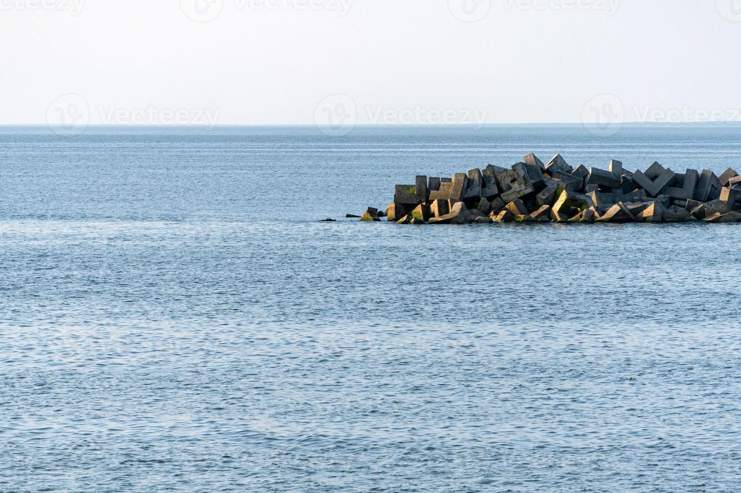 Minimalism seascape, Breathtaking view of sea with breakwaters, Traveling dreams, copy space, Clean blue sea water. photo