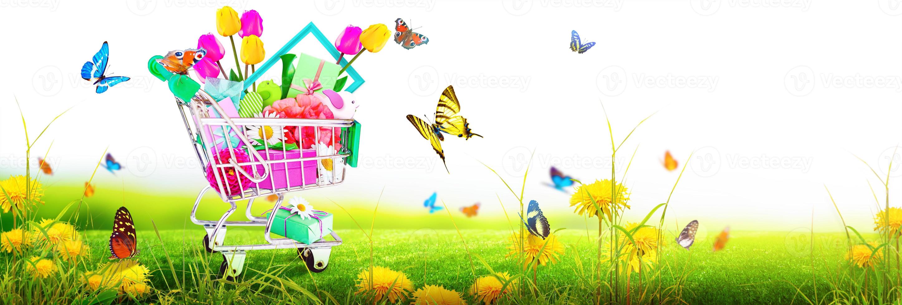 Mini shopping cart with colorful flowers and butterflies. photo