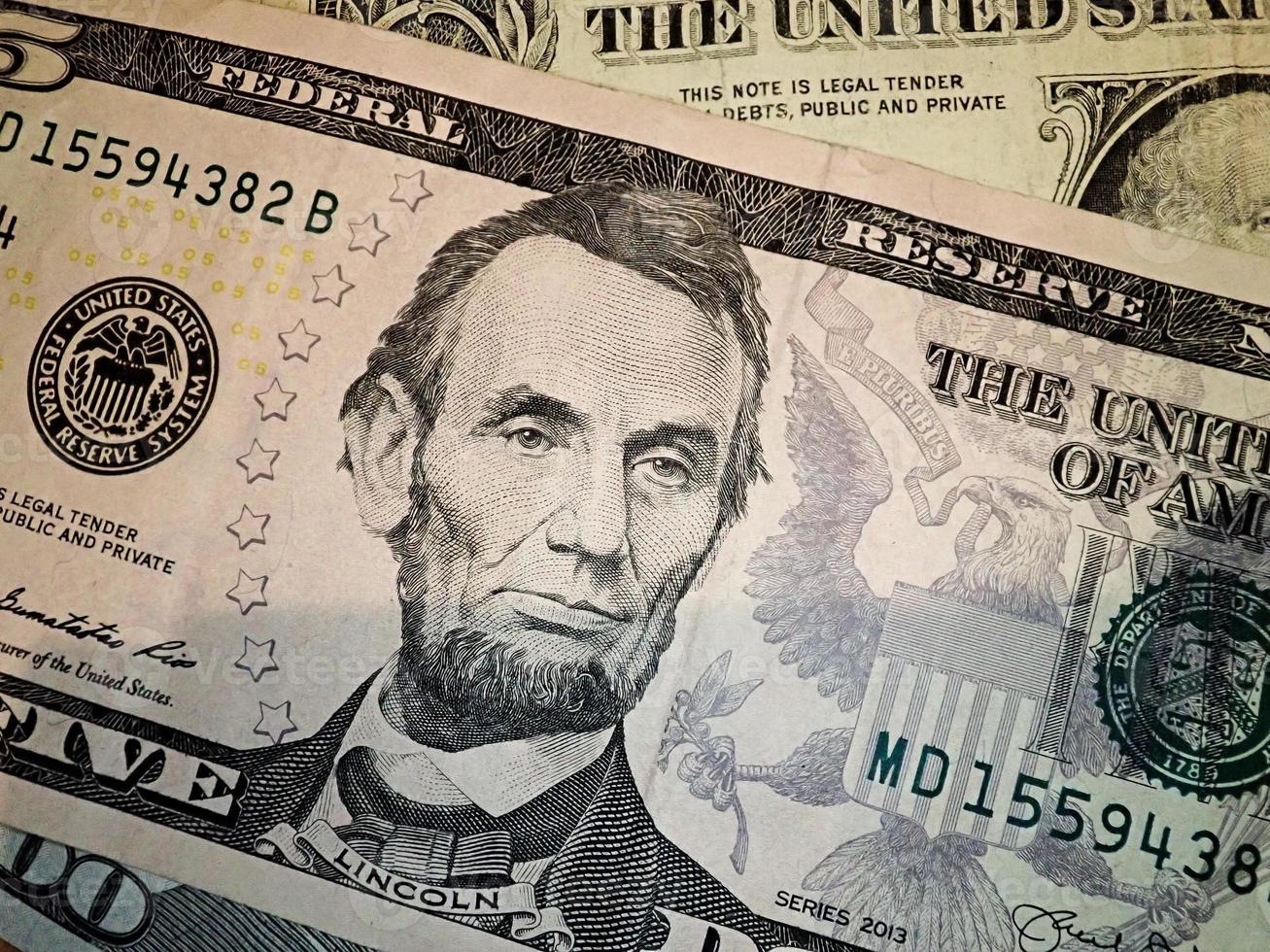 Abraham Abe Lincoln face portrait on 5 dollar bill macro. United states money. photo