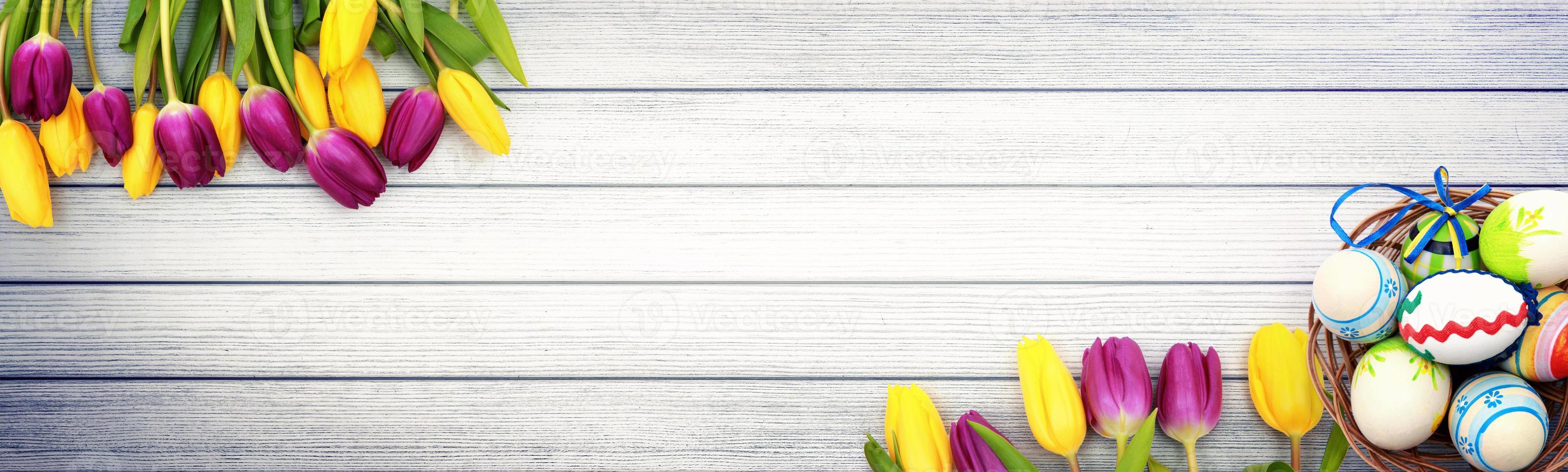 Beautiful Easter background with colorful tulips and easter eggs. photo