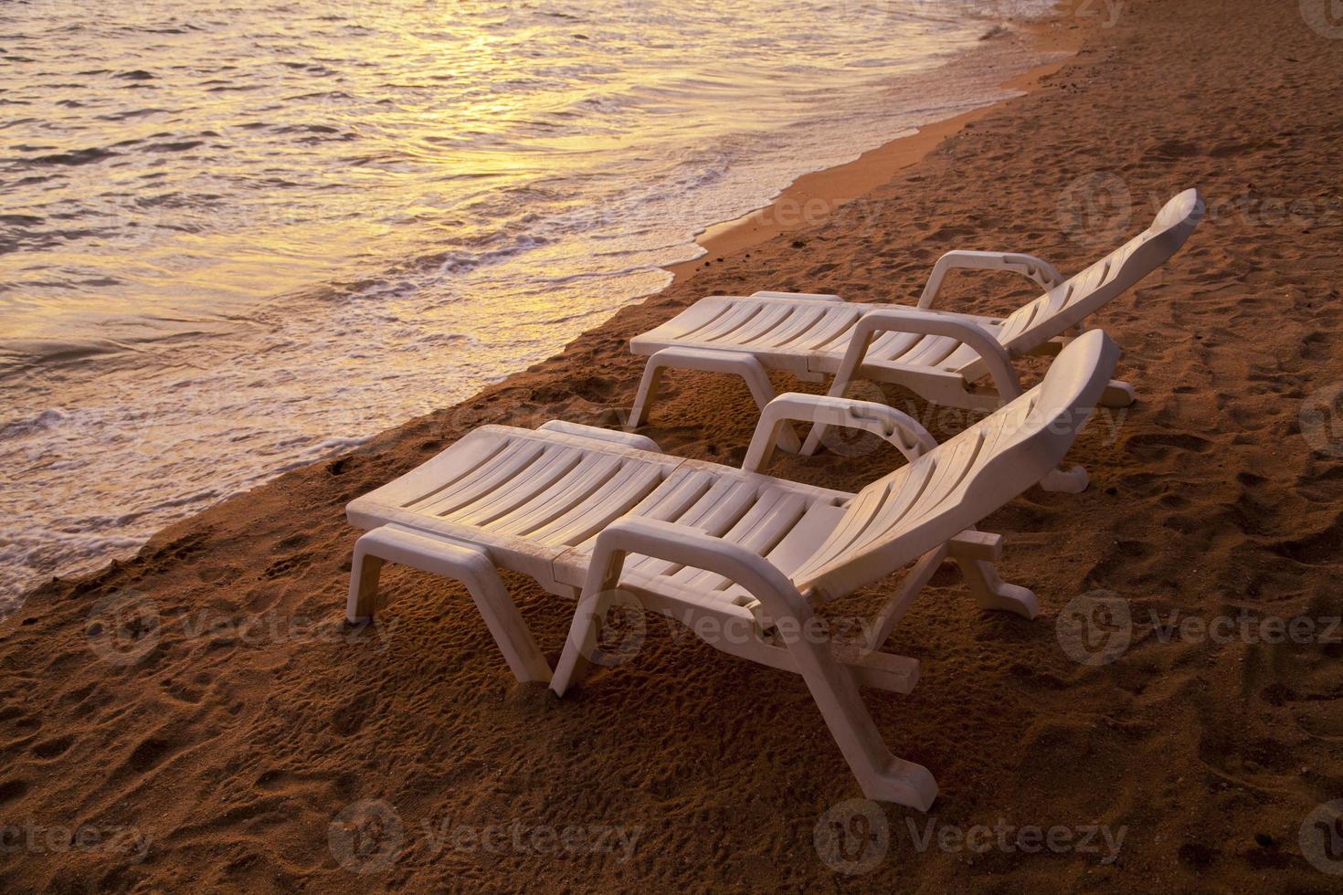 sunset over sea Pataya beach Thailand with beach chair photo