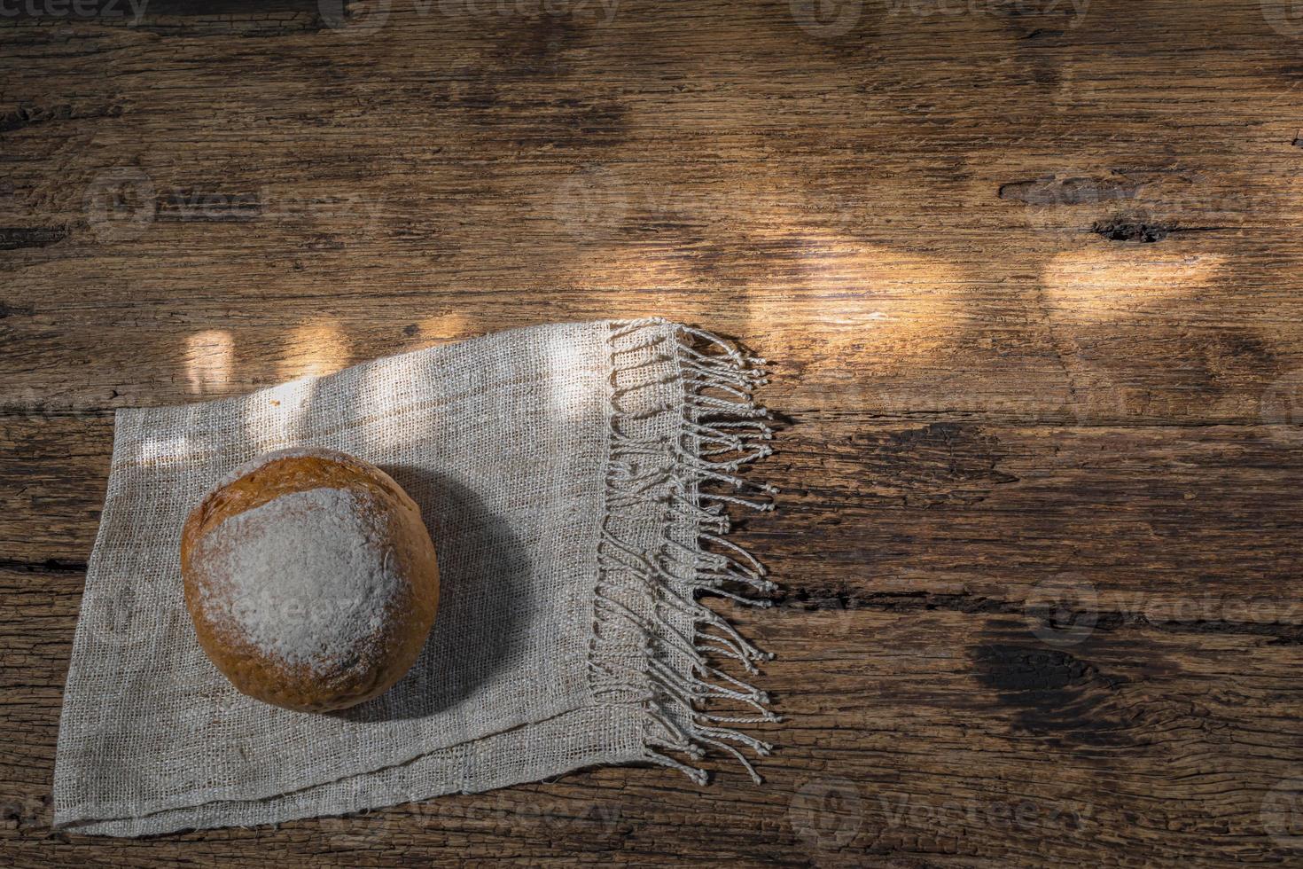 round bread isolated on wood background photo