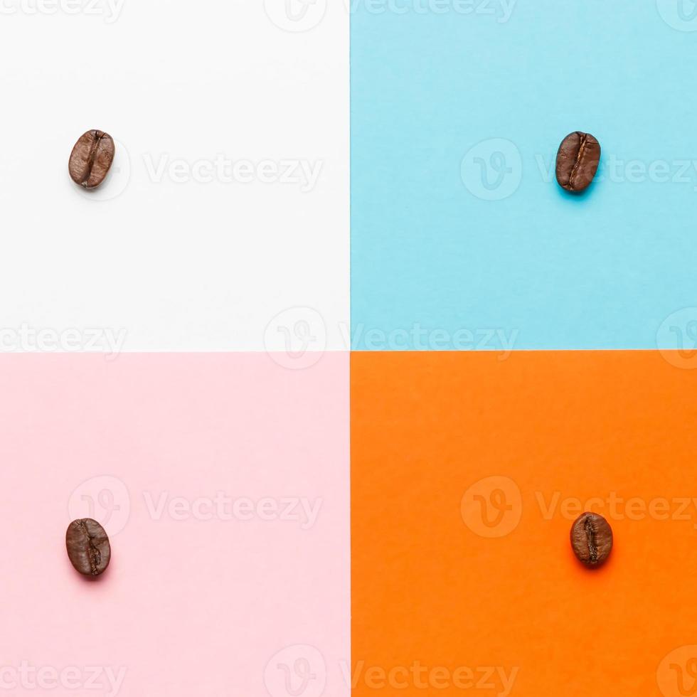 Composition of coffee beans on white, blue, orange and pink background. photo