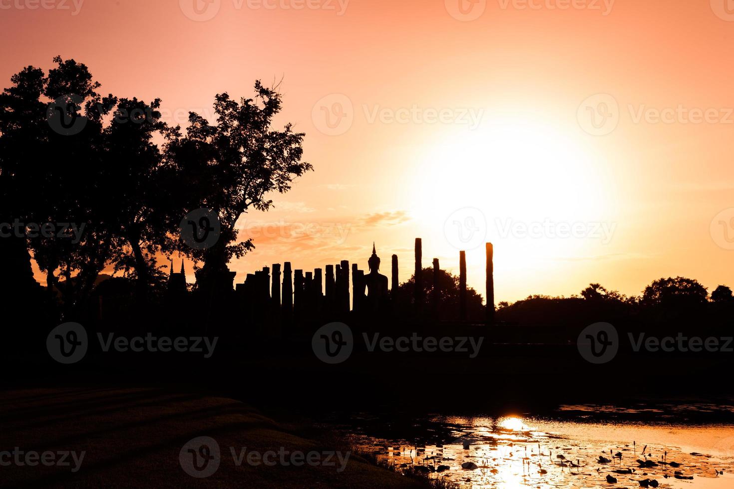 Silhouette Buddha Statue in Wat Mahathat Temple in Sukhothai Historical Park, Sukhothai Province, Thailand . photo