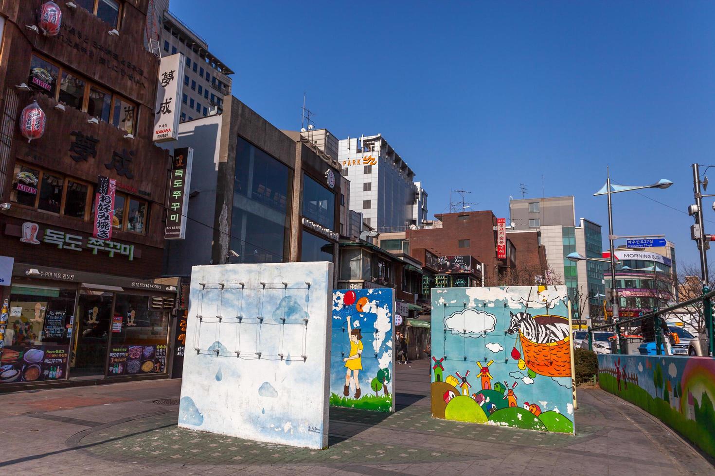 Street view of Hongdae Area , Hongik on March 8 2014, in Seoul South Korea. Place to show art and shopping district famous. Art market is open every Saturday photo